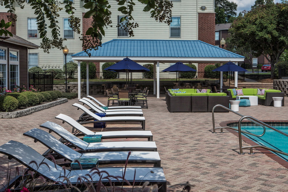 outdoor pool area with lounge chairs at the beacon apartments